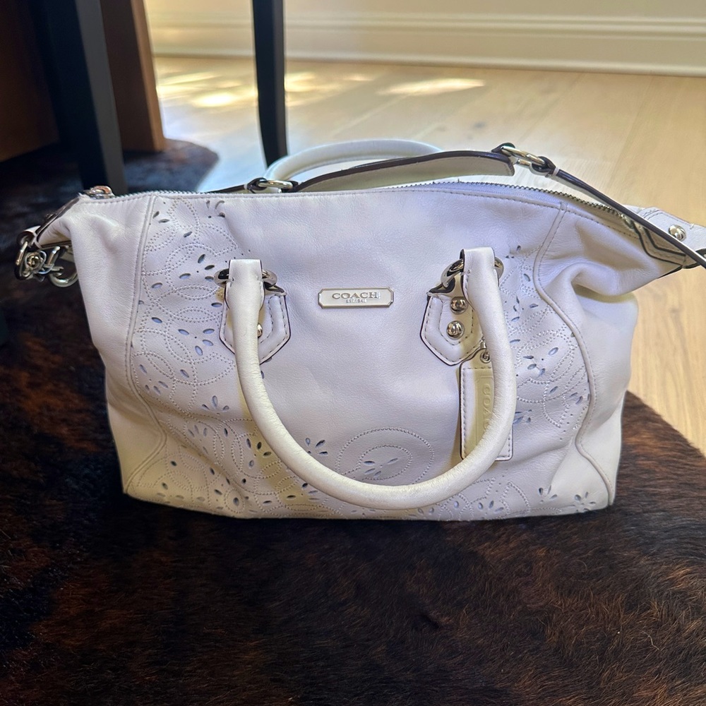 White Coach large eyelet cutout leather shoulder carryall bag.